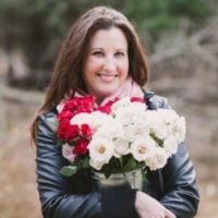 Kristy Tracey outdoors holding floral bouquet