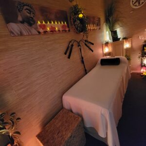 Holistic Healing Room at The Zen Shop with Reiki bed, Buddha artwork, selenite towers, salt lamps, and ambient candlelight creating a serene treatment space